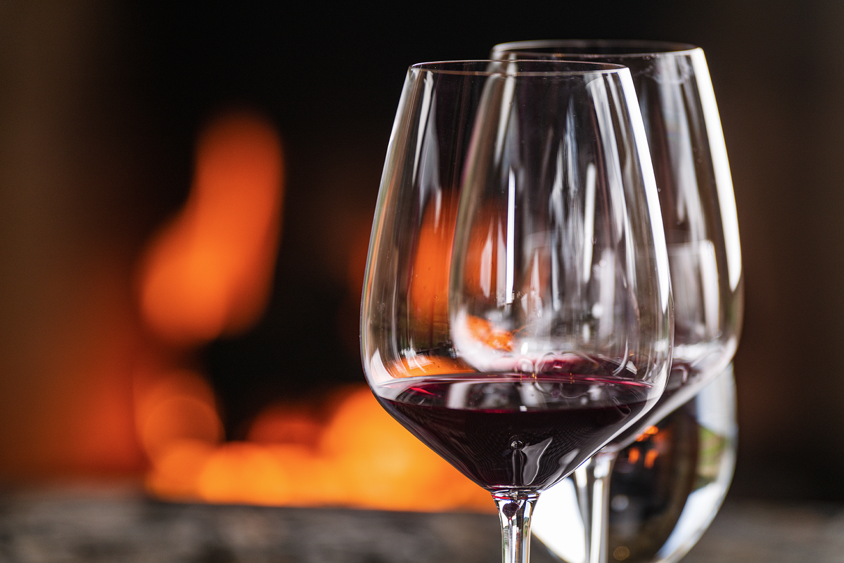 Glasses of Skipstone red wine beside the fire